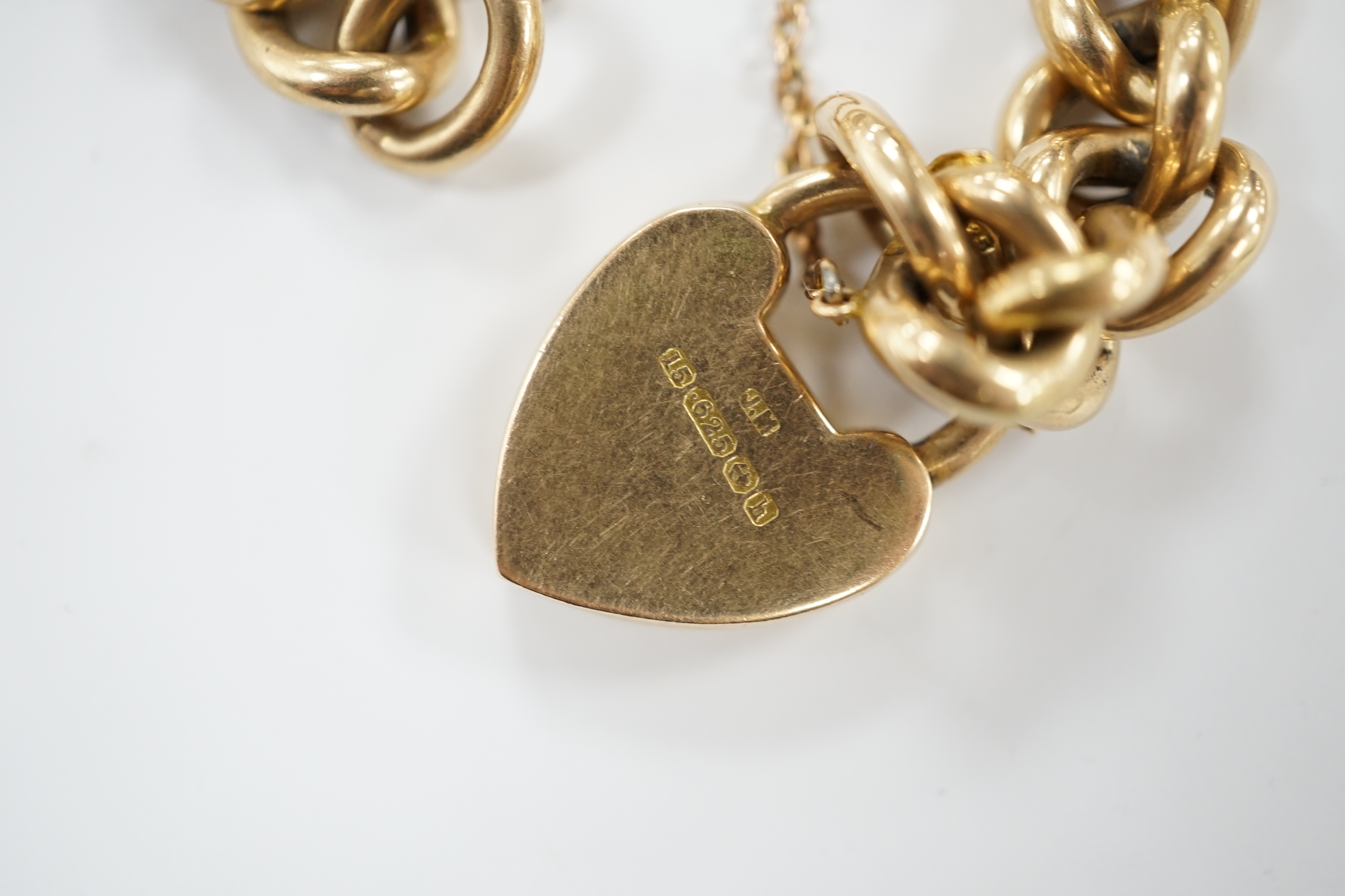 An Edwardian 15ct gold curb link bracelet, with heart shaped padlock clasp, 20cm